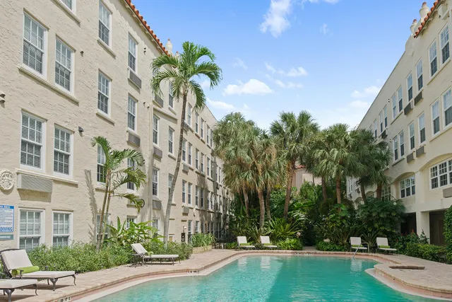 a view of a chair and tables in the backyard of a house