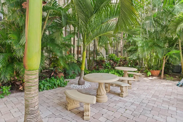 a living room with patio furniture and a chandelier