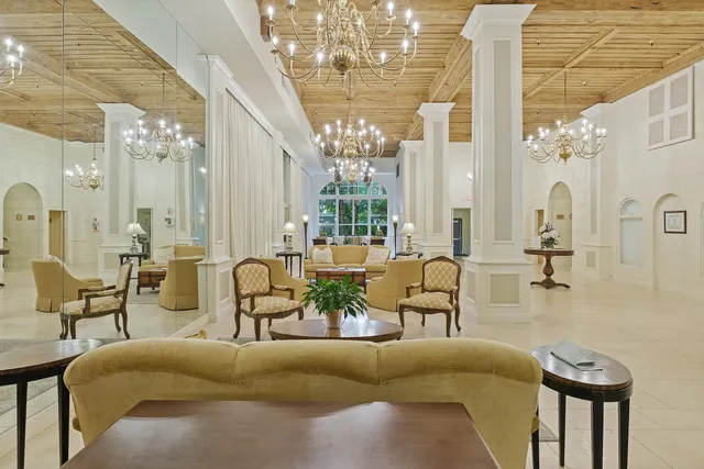 a view of a balcony with dining table and chairs