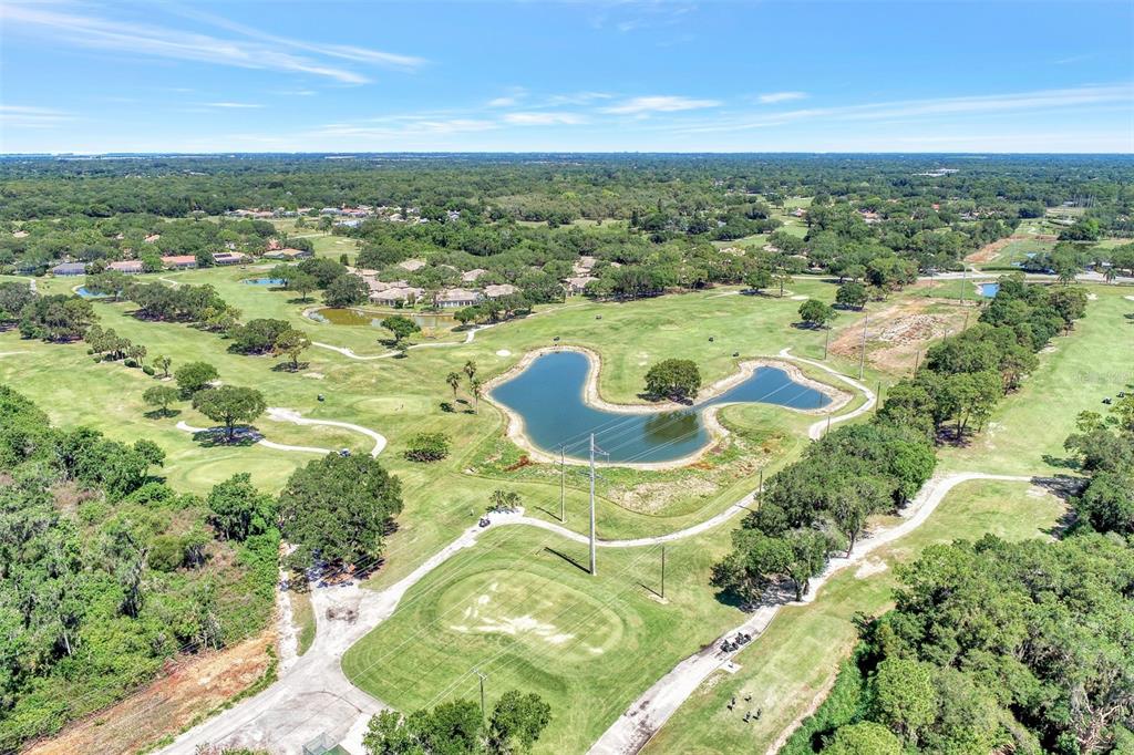 5103 Greencroft Road Sarasota, FL 34235 - Photo 18 of 25 an aerial view of residential houses with outdoor space and trees