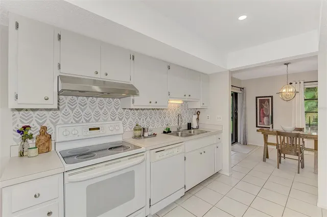 a dining room with furniture a chandelier and window