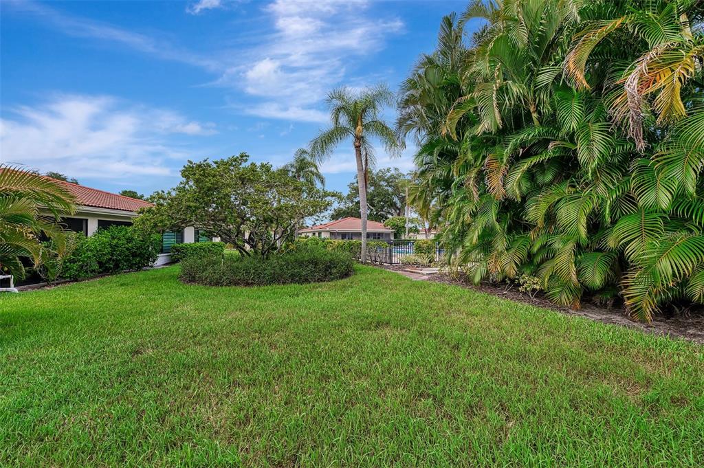 5103 Greencroft Road Sarasota, FL 34235 - Photo 9 of 25 a view of a garden with a building in the background