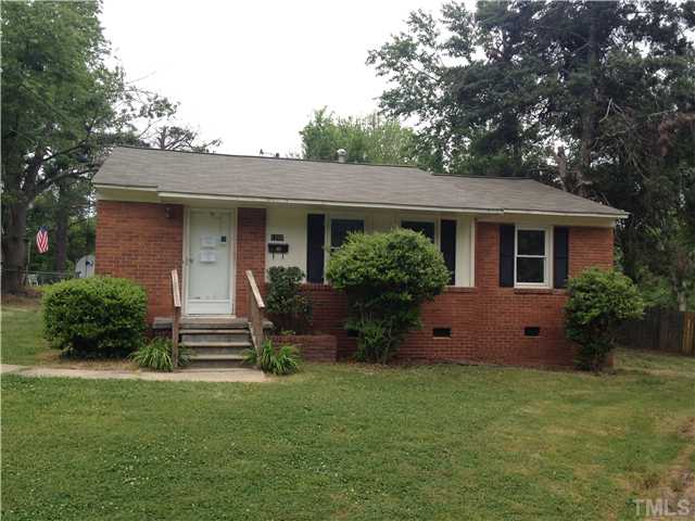 a front view of house with a garden