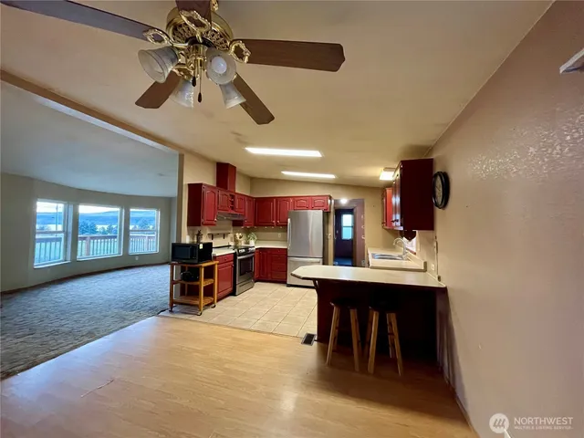 a view of a room with furniture and chandelier