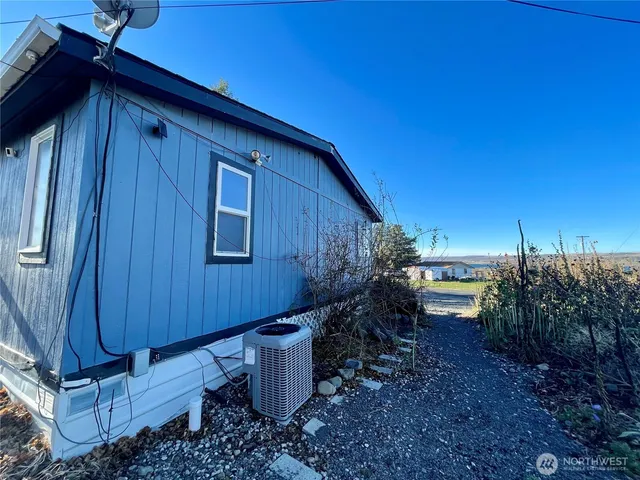 a view of a backyard with plants and outdoor seating