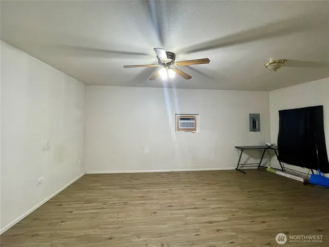 a room with ceiling fan and windows