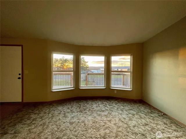 an empty room with a empty space and windows