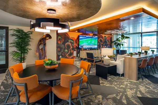 a outdoor space with the couches and dining table with the potted plants