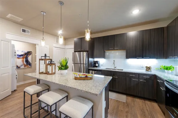 a kitchen with sink cabinets and wooden floor
