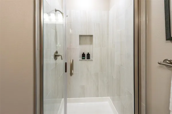 a bathroom with a granite countertop sink toilet and mirror