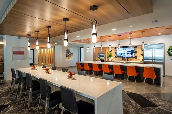 a large kitchen with a table and chairs