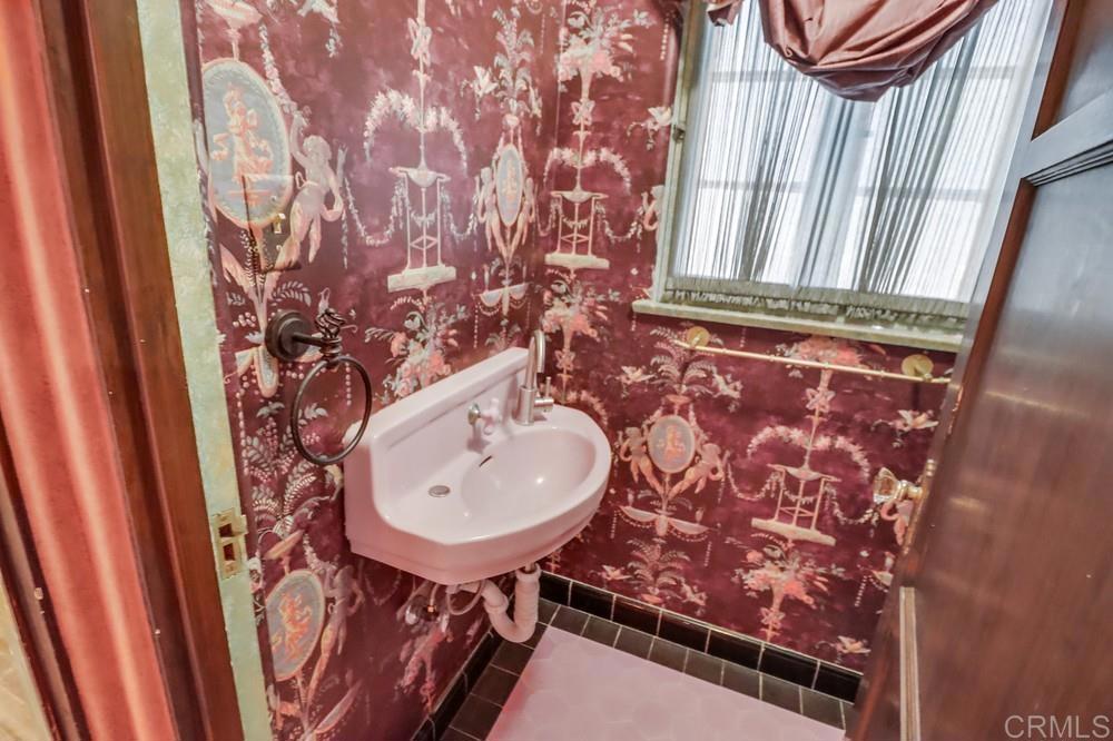 3014 Xenophon Street San Diego, CA 92106 - Photo 22 of 73 a bathroom with a sink and mirror with toilet