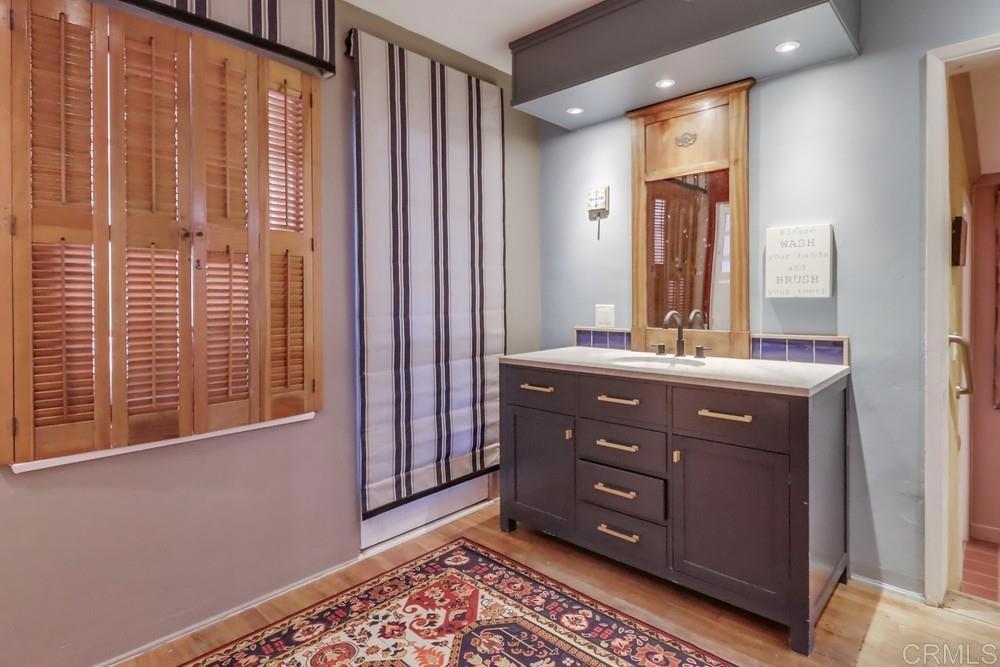 3014 Xenophon Street San Diego, CA 92106 - Photo 24 of 73 a bathroom with a sink a mirror and a window