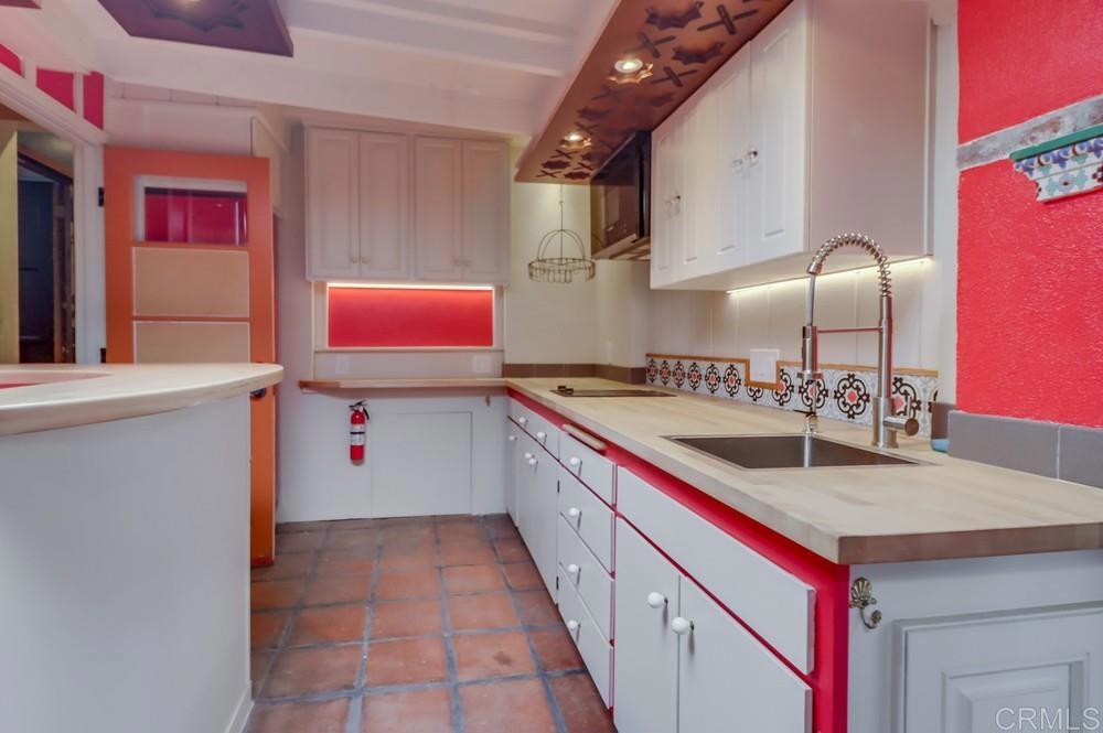 3014 Xenophon Street San Diego, CA 92106 - Photo 31 of 73 a kitchen with stainless steel appliances granite countertop a sink and dishwasher refrigerator a microwave