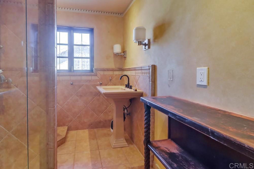 3014 Xenophon Street San Diego, CA 92106 - Photo 42 of 73 a bathroom with a sink a mirror and a bathtub