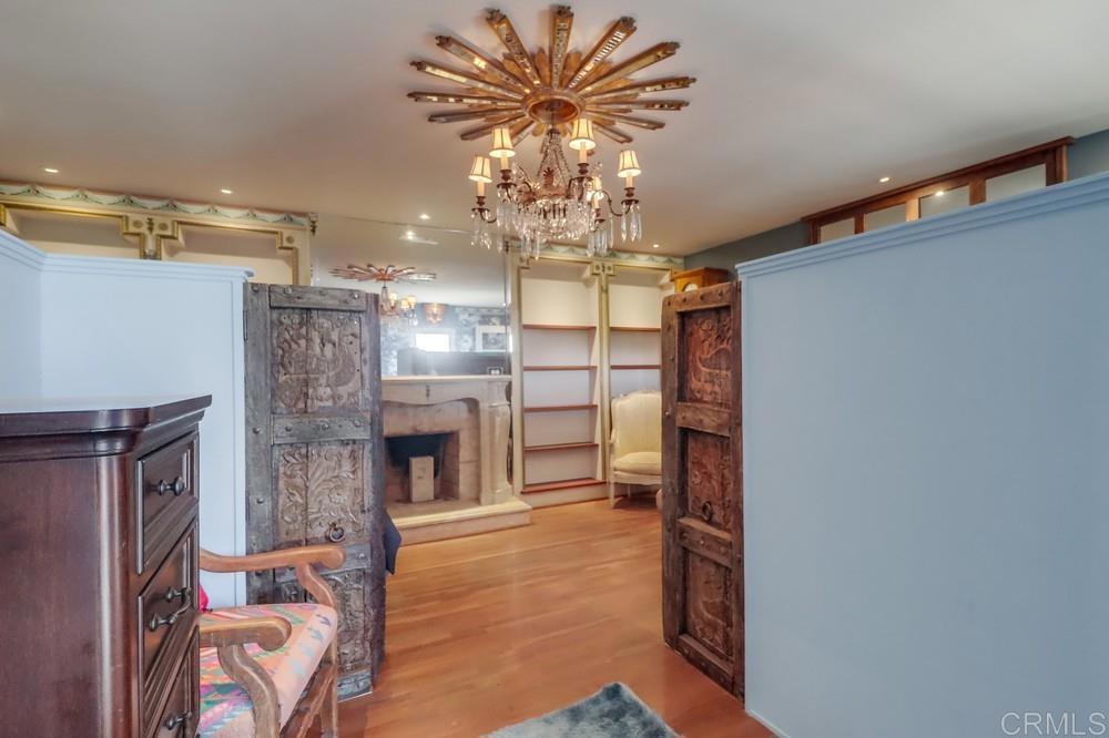 3014 Xenophon Street San Diego, CA 92106 - Photo 43 of 73 a view of a livingroom with a fireplace a chandelier and wooden floor