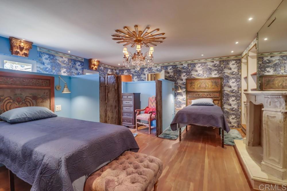 3014 Xenophon Street San Diego, CA 92106 - Photo 46 of 73 a bedroom with a bed and chandelier