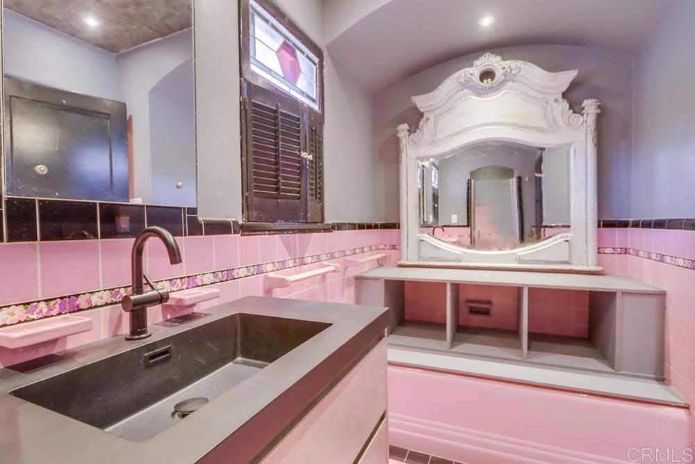 3014 Xenophon Street San Diego, CA 92106 - Photo 57 of 73 a bathroom with a sink and a large mirror