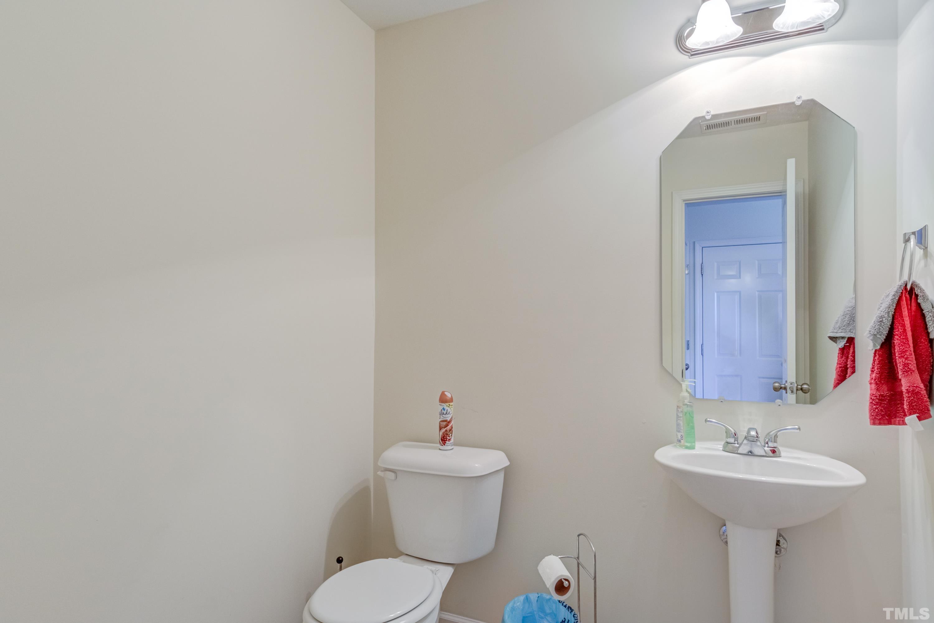 2925 Filbert Street Raleigh, NC 27610 - Photo 11 of 21 a bathroom with a toilet sink and mirror