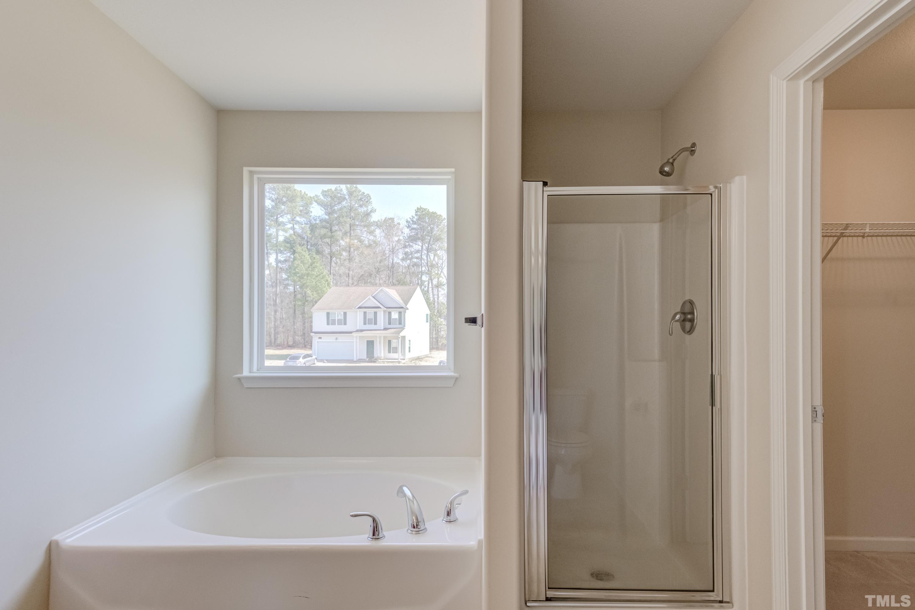 2925 Filbert Street Raleigh, NC 27610 - Photo 15 of 21 a white bath tub sitting next to a window