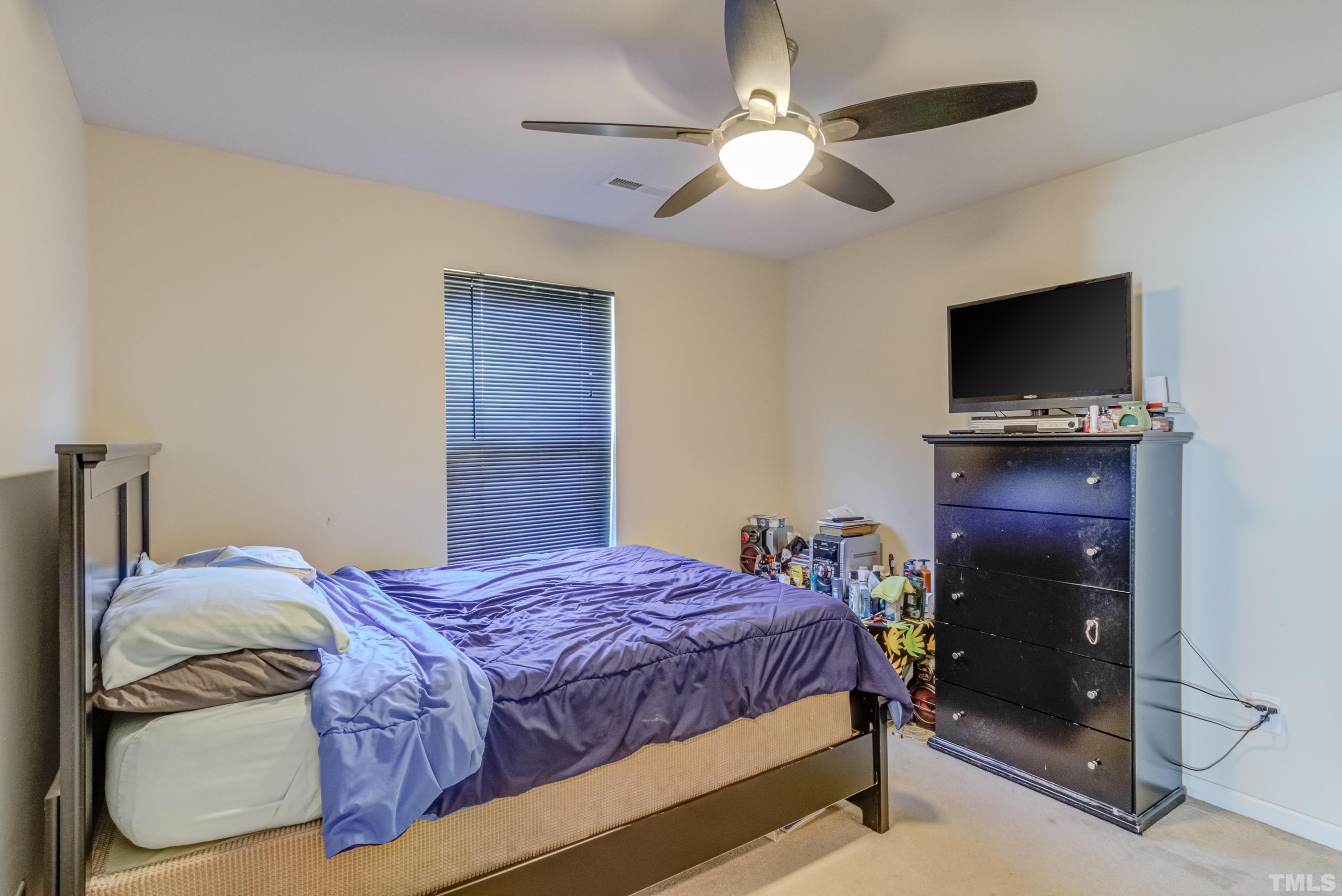 2925 Filbert Street Raleigh, NC 27610 - Photo 16 of 21 a bedroom with a bed and a flat screen tv
