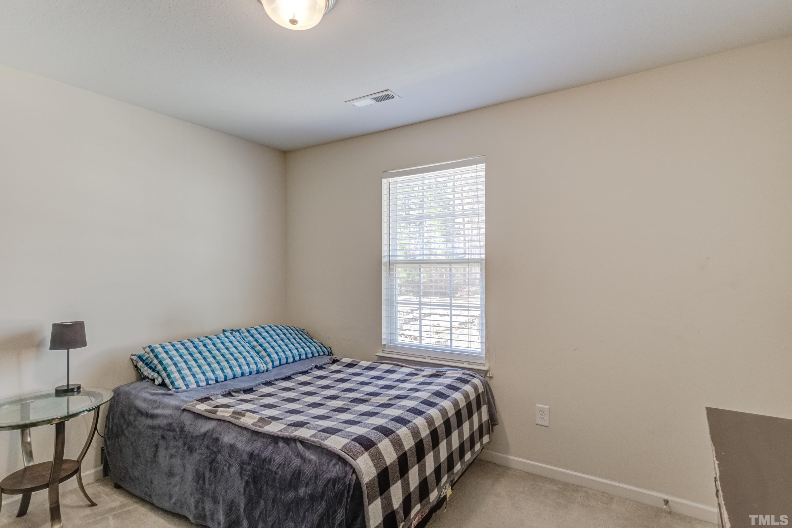 2925 Filbert Street Raleigh, NC 27610 - Photo 18 of 21 a bedroom with a bed and a window