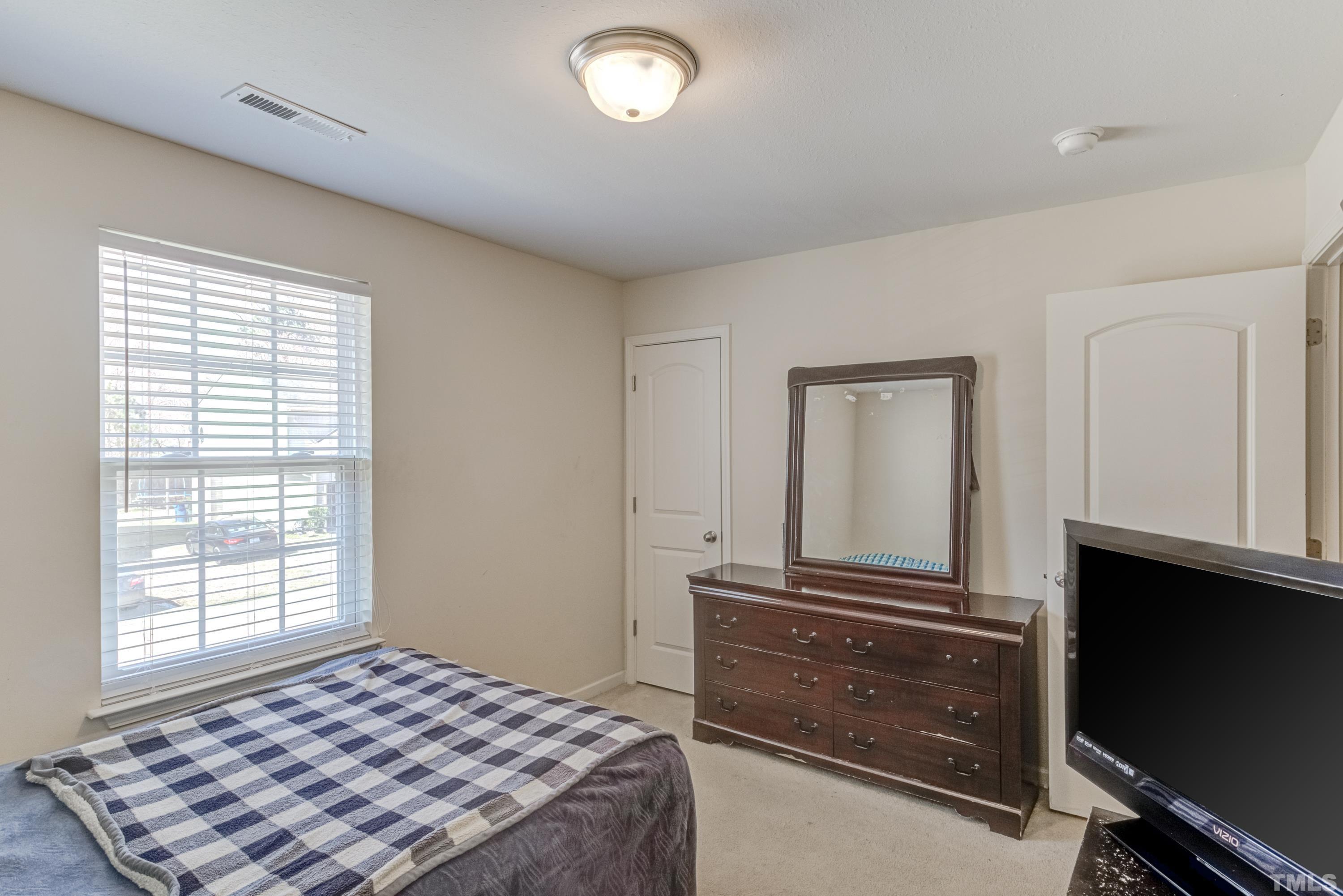 2925 Filbert Street Raleigh, NC 27610 - Photo 19 of 21 a bedroom with a bed and a dresser