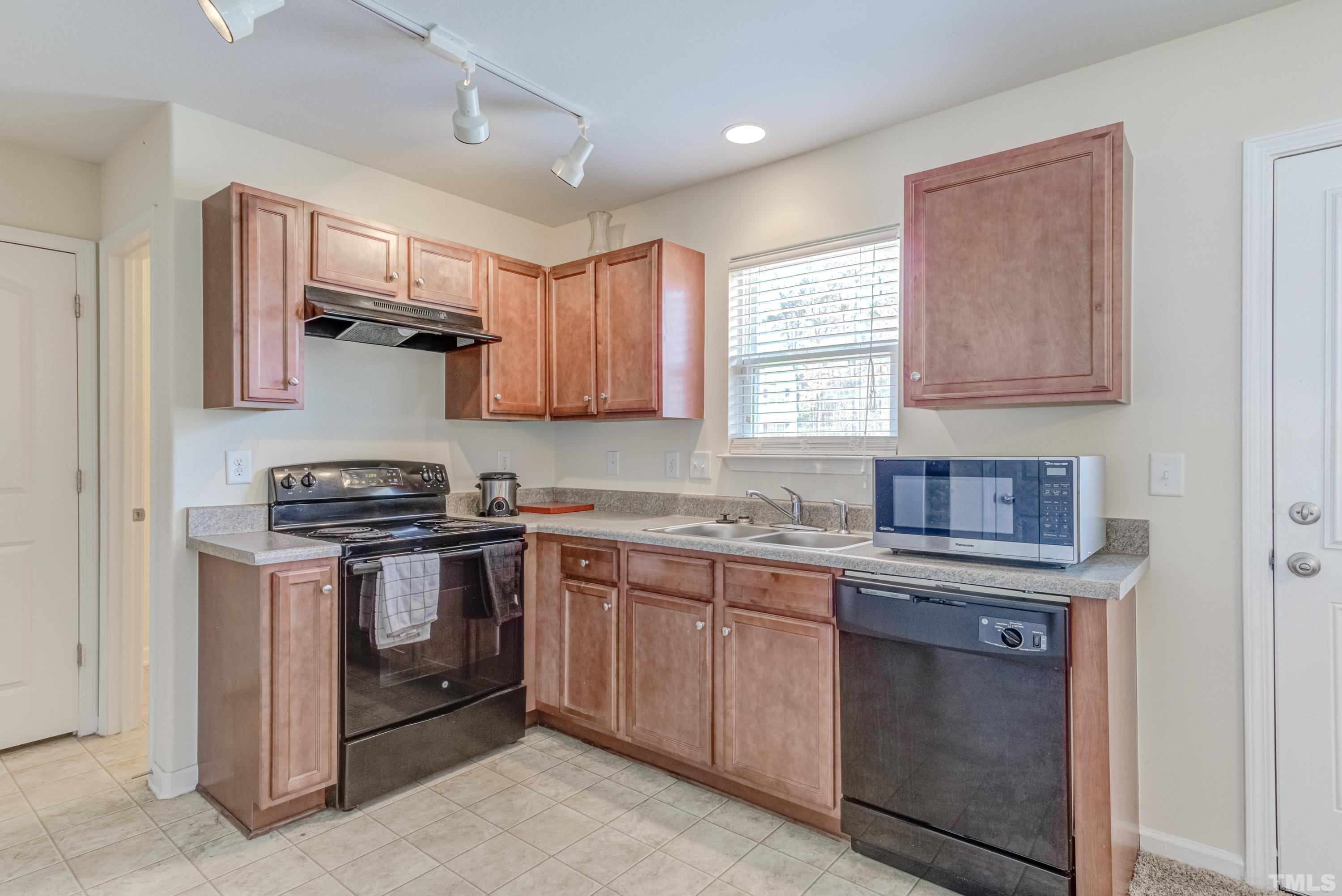 2925 Filbert Street Raleigh, NC 27610 - Photo 8 of 21 a kitchen with stainless steel appliances granite countertop a stove sink and microwave
