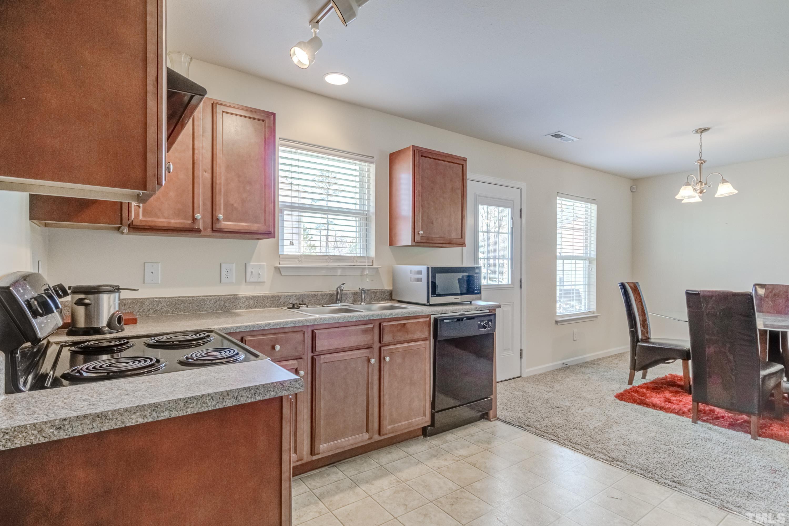2925 Filbert Street Raleigh, NC 27610 - Photo 9 of 21 a kitchen with a stove a sink and a refrigerator