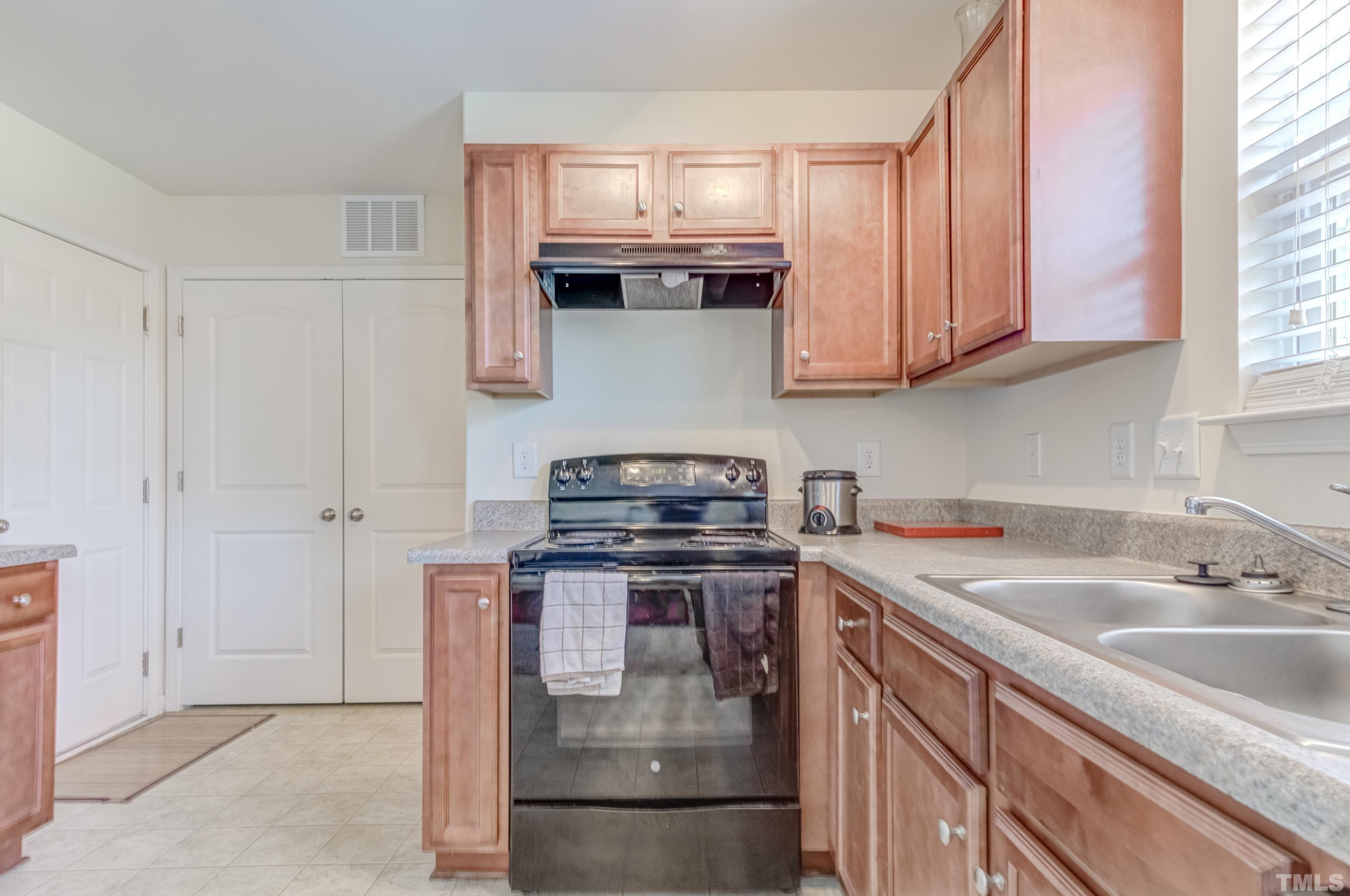 2925 Filbert Street Raleigh, NC 27610 - Photo 10 of 21 a kitchen with stainless steel appliances granite countertop a sink stove and refrigerator