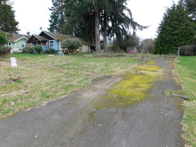 959 Rose Avenue Vernonia, OR 97064 - Photo 4 of 13 a view of a house with a yard and palm trees