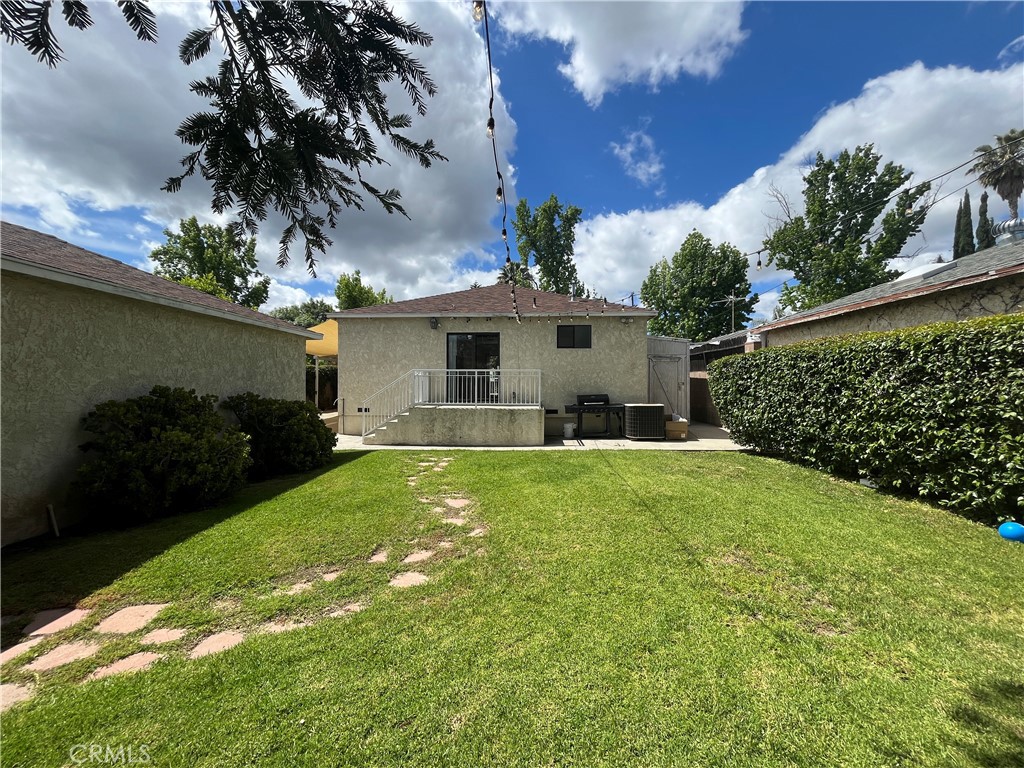 18029 Santa Rita Street Encino, CA 91316 - Photo 20 of 20 a front view of a house with garden