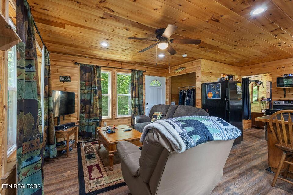 63 County Road 100 Decatur, TN 37322 - Photo 36 of 46 a living room with furniture a flat screen tv and a large window