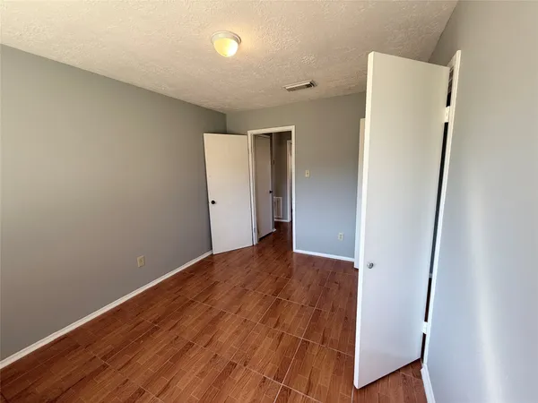 an empty room with wooden floor