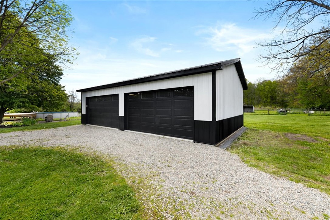 5120 Wheelock Road Troy, OH 45373 - Photo 51 of 67 This spacious garage offers ample storage for vehicles and equipment, featuring a durable metal roof.