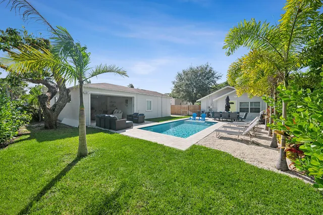 a front view of a house with a yard and green space