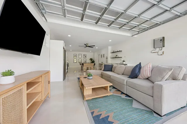 a living room with furniture a flat screen tv and a fireplace