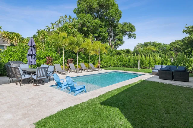 a view of a backyard with sitting area