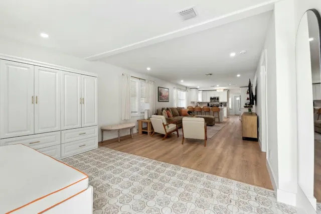 a living room with furniture and white appliances