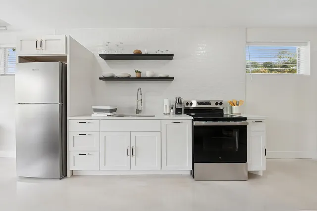 a kitchen with stainless steel appliances a refrigerator and cabinets