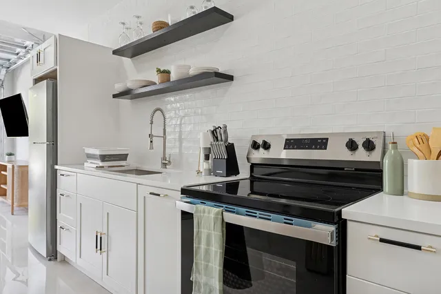 a kitchen with appliances cabinets and a sink