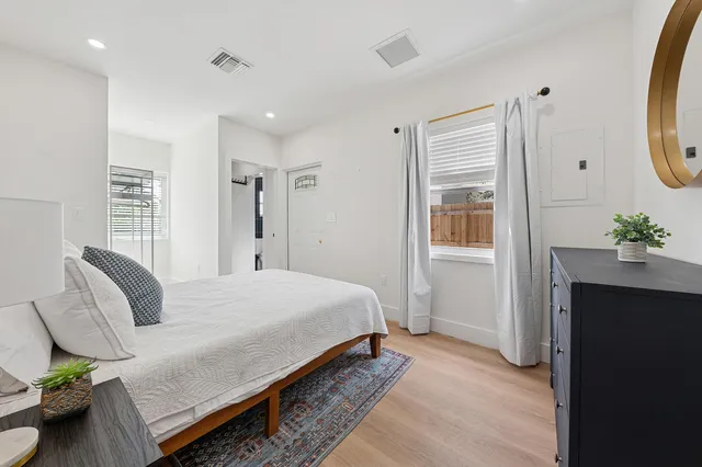 a bedroom with a bed and a potted plant
