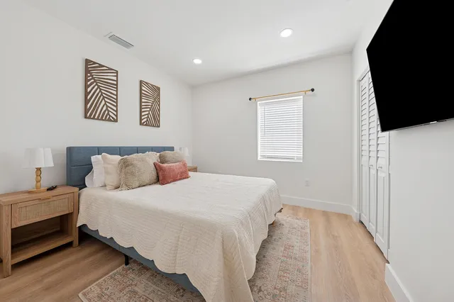 a bedroom with a bed and a flat screen tv