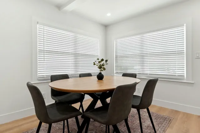 a dining room with furniture and window