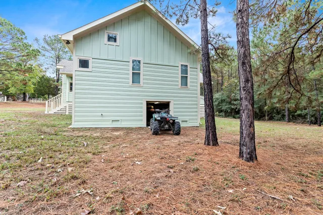 a green field with trees in the background