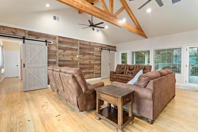 a living room with furniture a ceiling fan and a rug