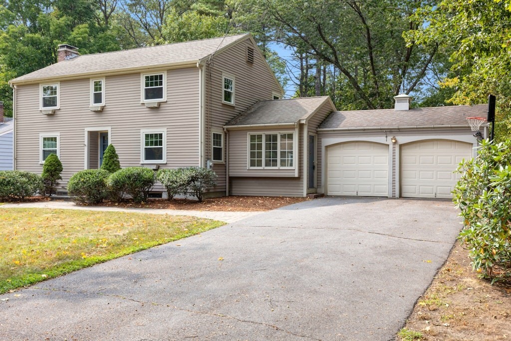 54 Mohawk Drive Acton, MA 01720 - Photo 1 of 42 a front view of a house with a yard and garage