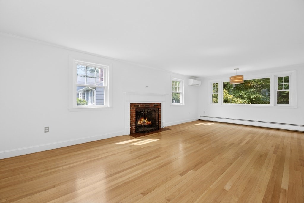 54 Mohawk Drive Acton, MA 01720 - Photo 13 of 42 an empty room with windows and fireplace