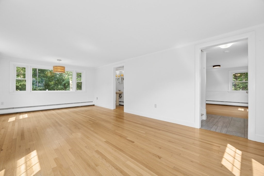 54 Mohawk Drive Acton, MA 01720 - Photo 14 of 42 wooden floor in an empty room with a window