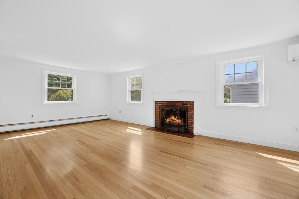 54 Mohawk Drive Acton, MA 01720 - Photo 15 of 42 an empty room with windows and fireplace